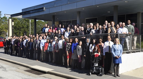 Staff standing in front of the building entrance